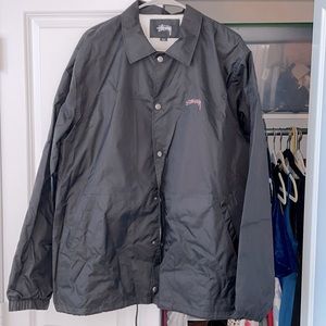 Stüssy Men’s Spring Coach black jacket with pink lettering
